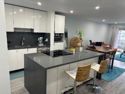 a kitchen with a sink cabinets and wooden floor