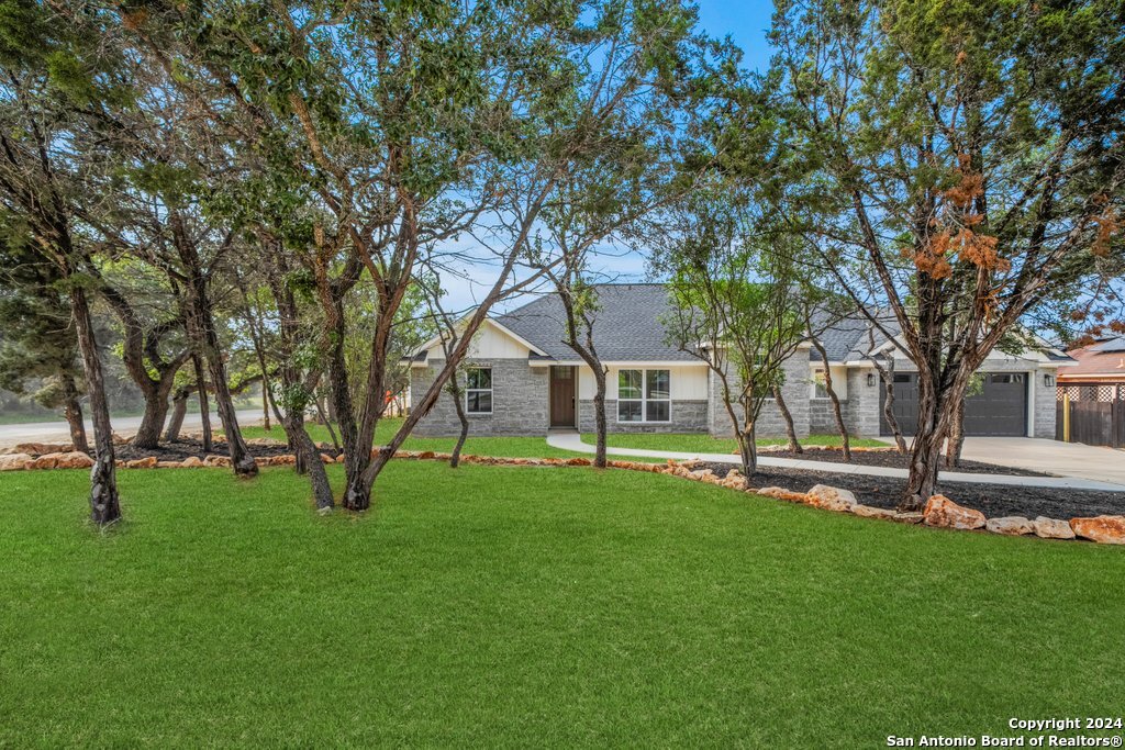 a view of a house with a backyard