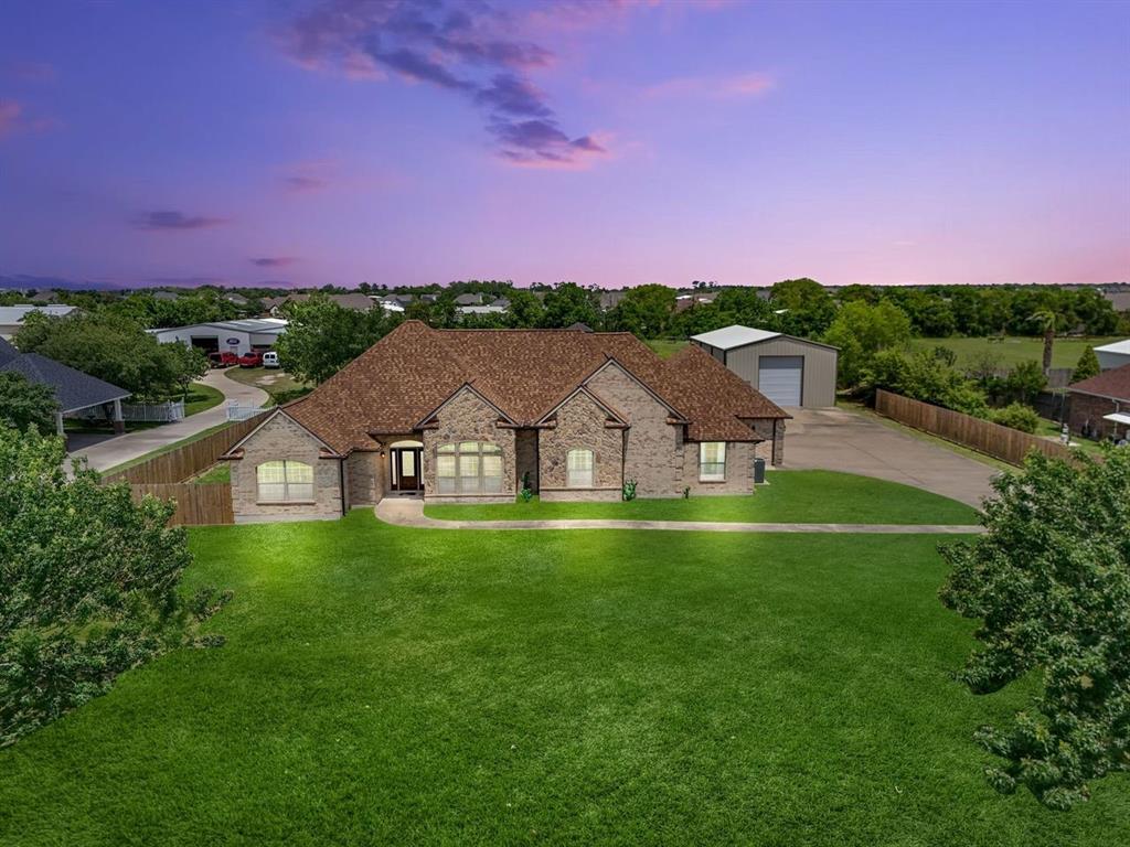 a front view of a house with a big yard