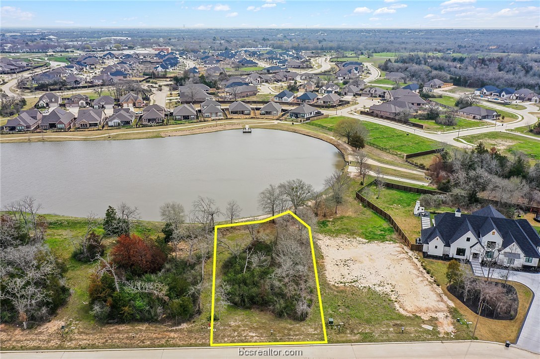 an aerial view of a house with a lake view