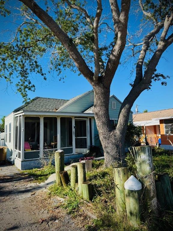 a view of a house with backyard porch and sitting area