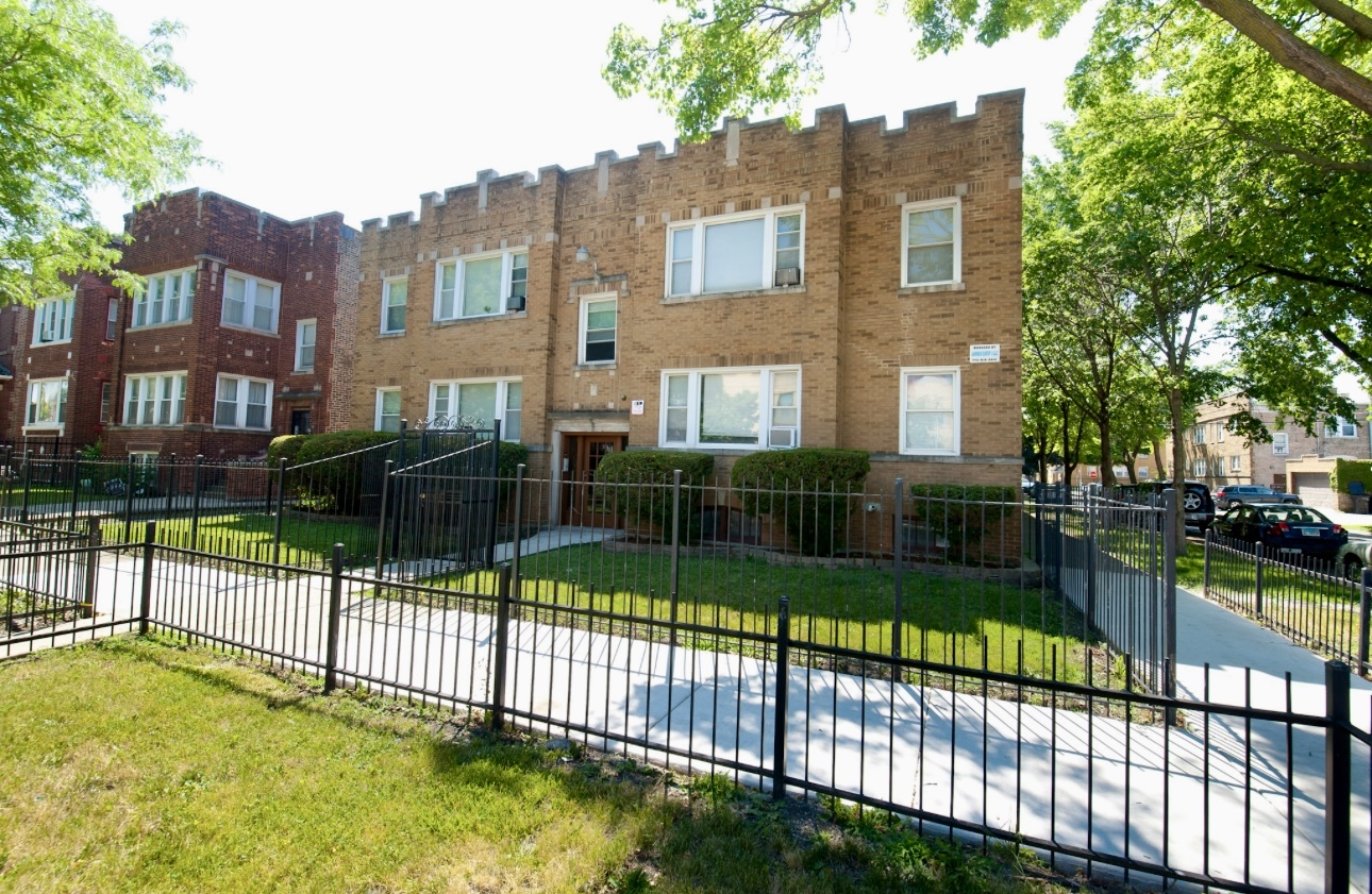 a view of a brick house next to a brick building