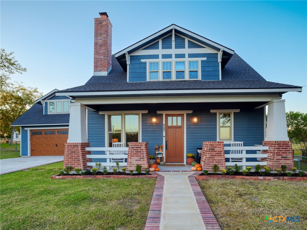 a front view of a house with a garden