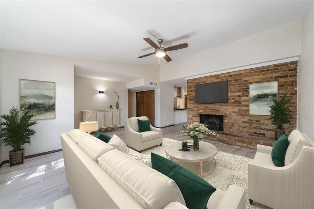 a living room with furniture a fireplace and a flat screen tv