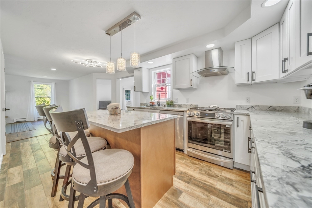 a kitchen with a stove cabinets and chairs