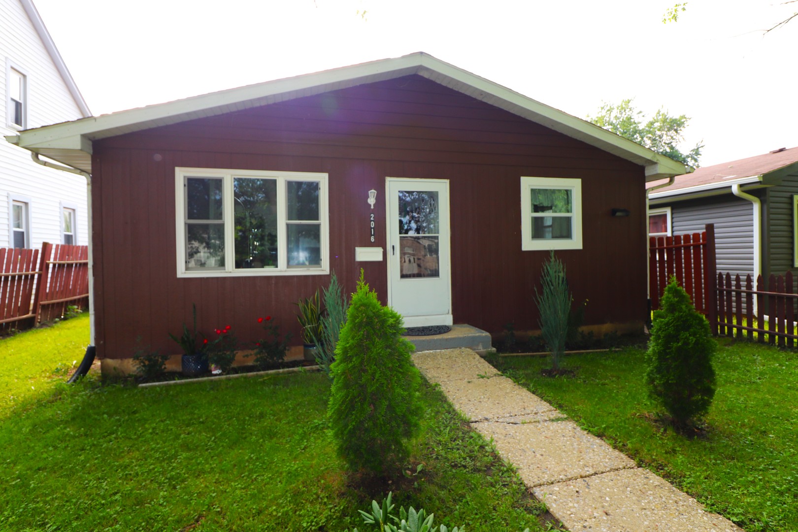 a front view of a house with garden