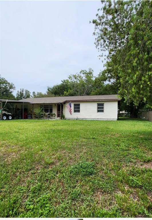 a front view of a house with yard and green space