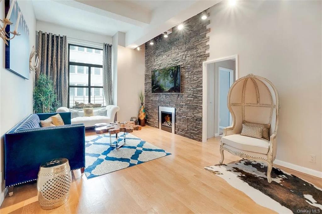 a living room with furniture a fireplace and a flat screen tv