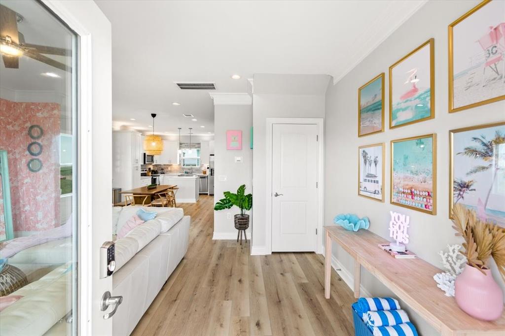 Walking in, you find a bright entryway with beautiful wood like flooring that continues throughout the main living areas making it easy to clean and maintain. With upgraded crown molding and chic design, this home shows like a model home on a prime lot!