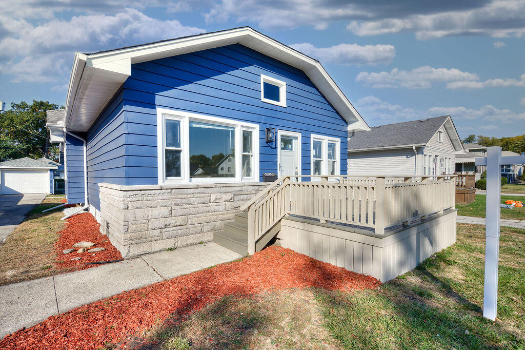 a view of a house with wooden deck