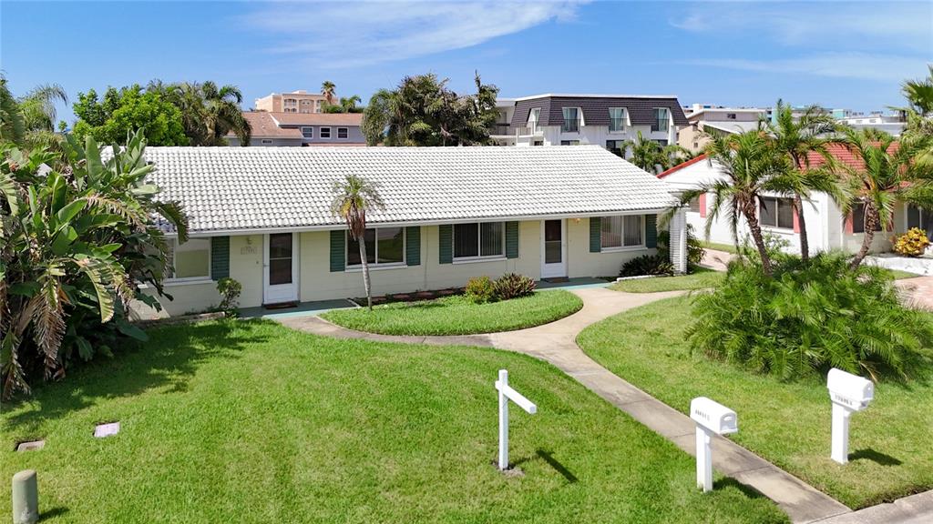 a aerial view of a house with a yard table and chairs