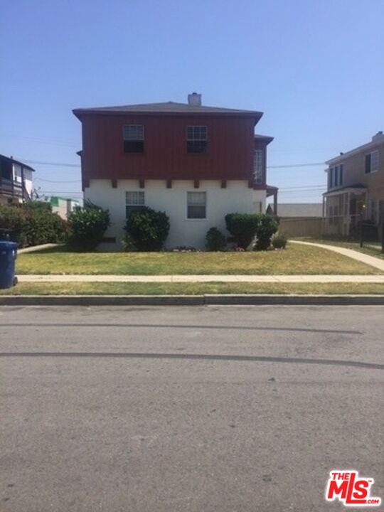 a view of a house with a yard and balcony