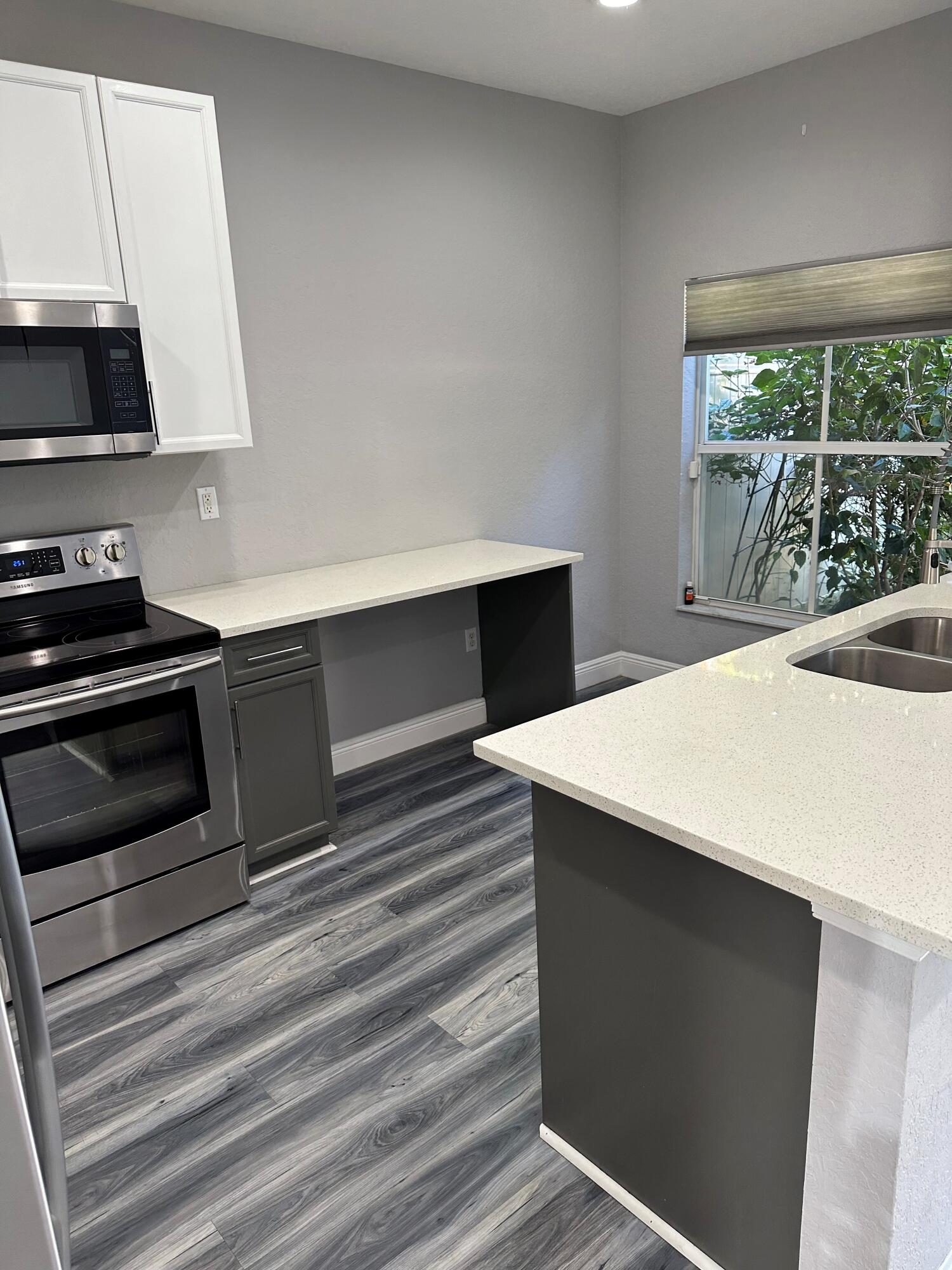 a kitchen with a stove and a white cabinet