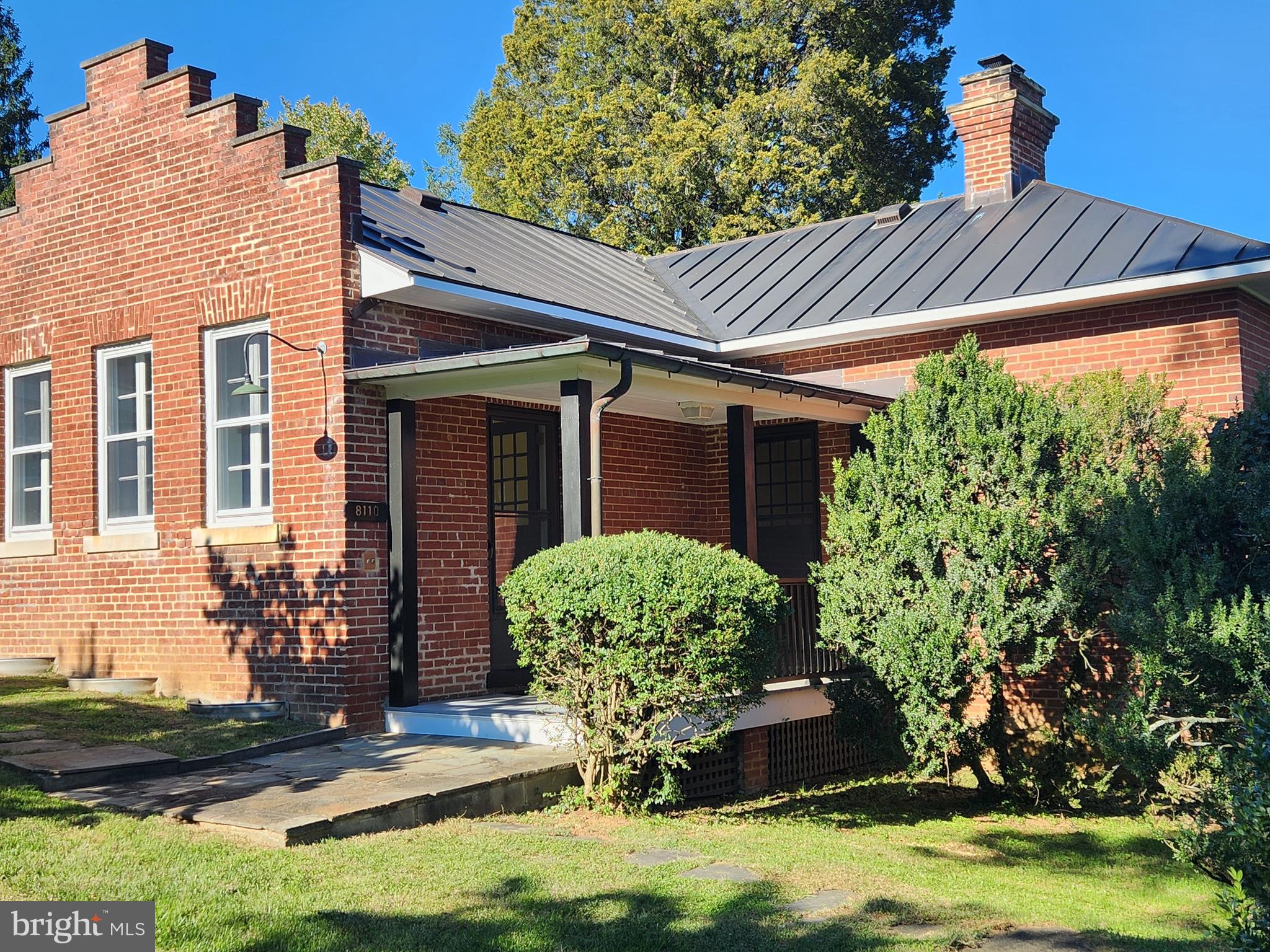 a view of a house with yard and sitting area