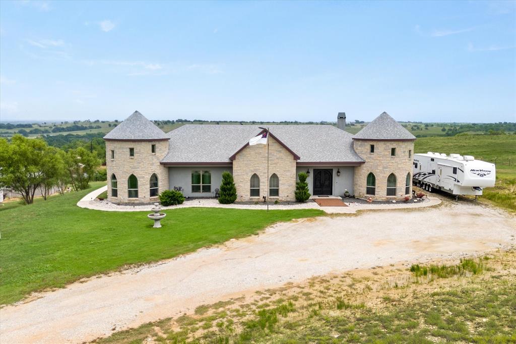 a front view of house with yard and green space