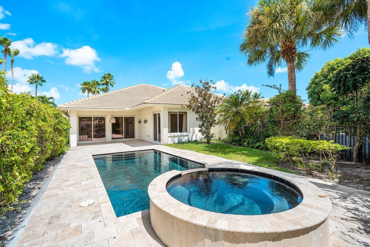 a view of a house with swimming pool and sitting area