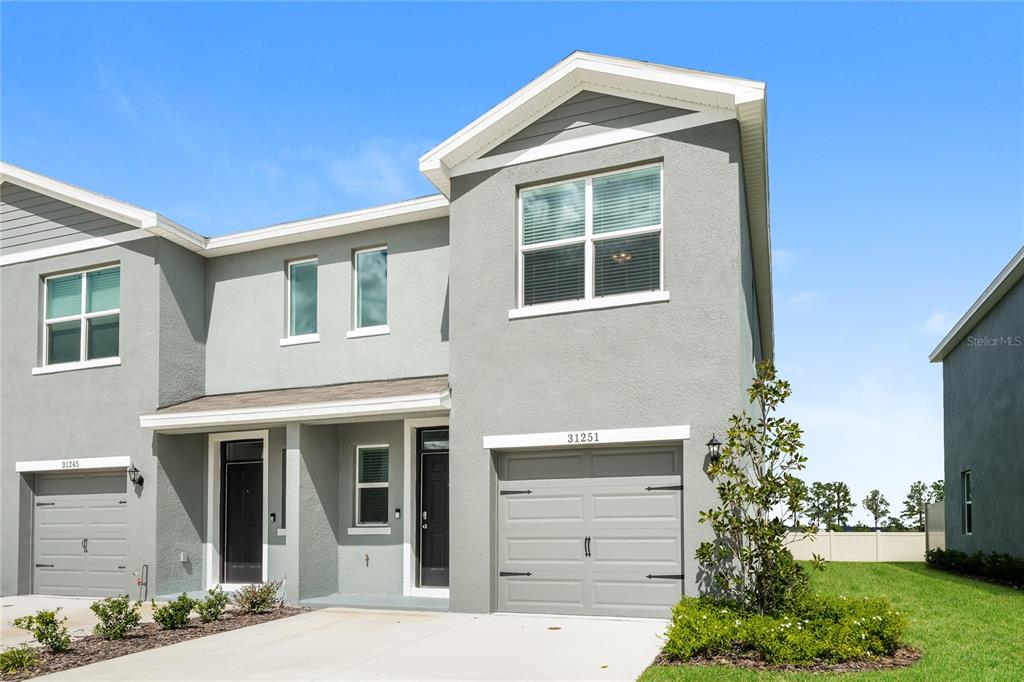 a front view of a house with a yard