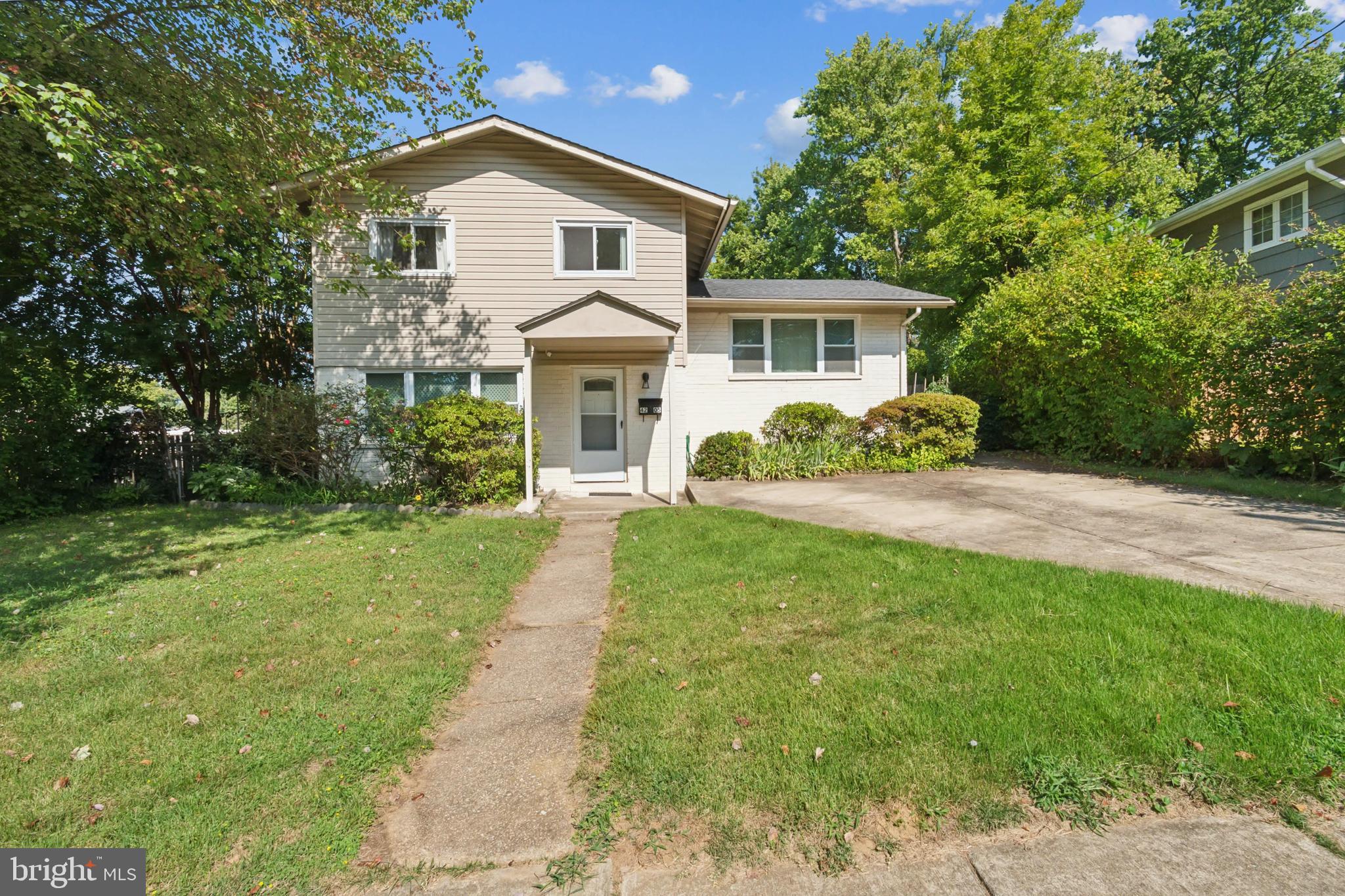 a front view of a house with a yard and porch