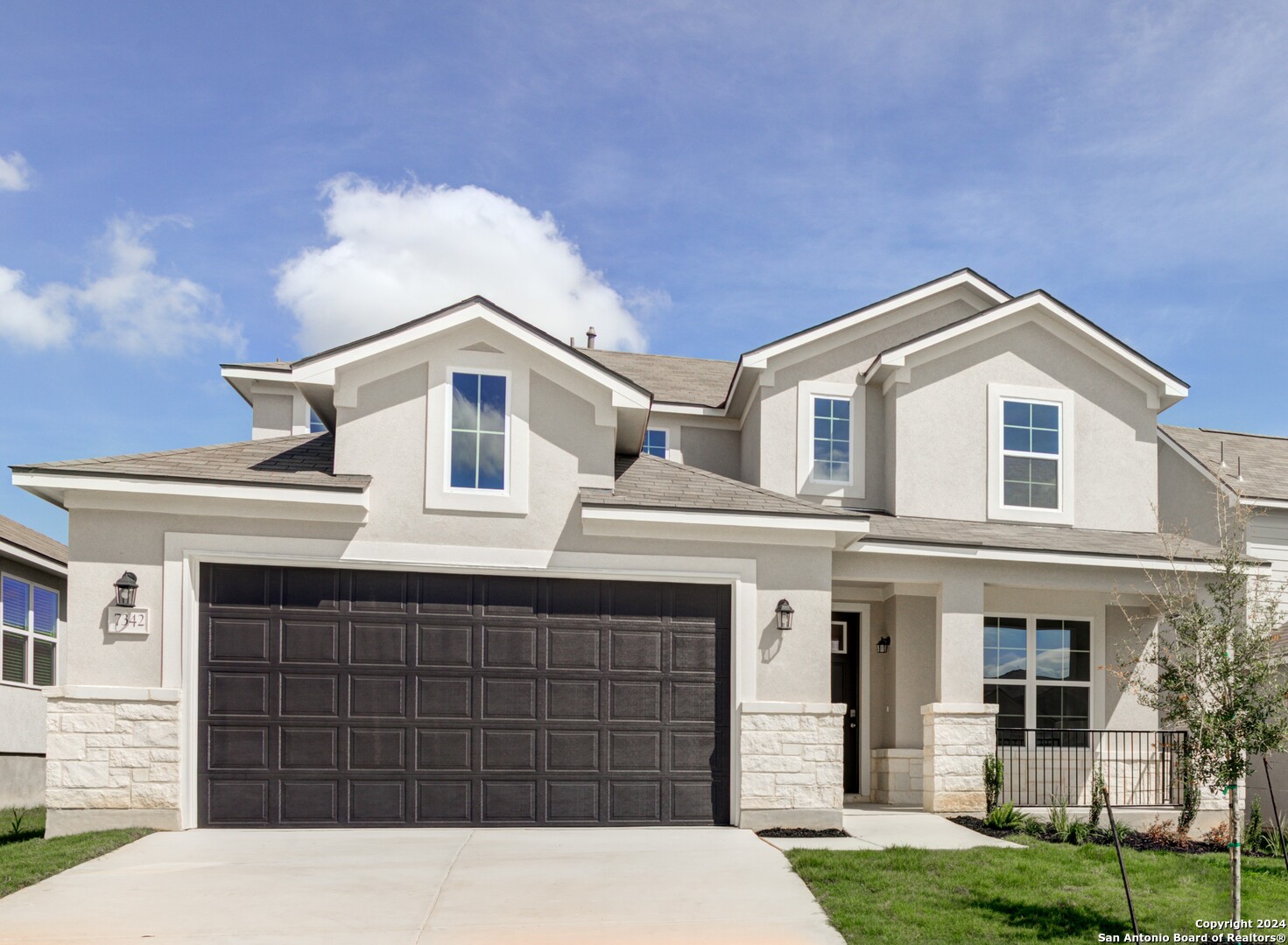 a front view of a house with a yard