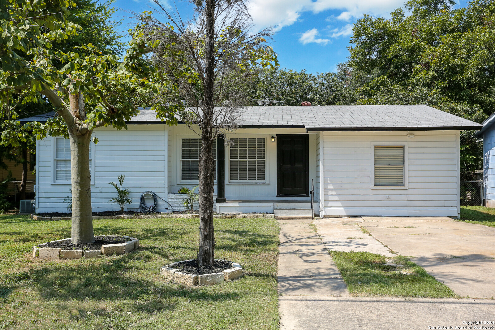 a front view of a house with garden