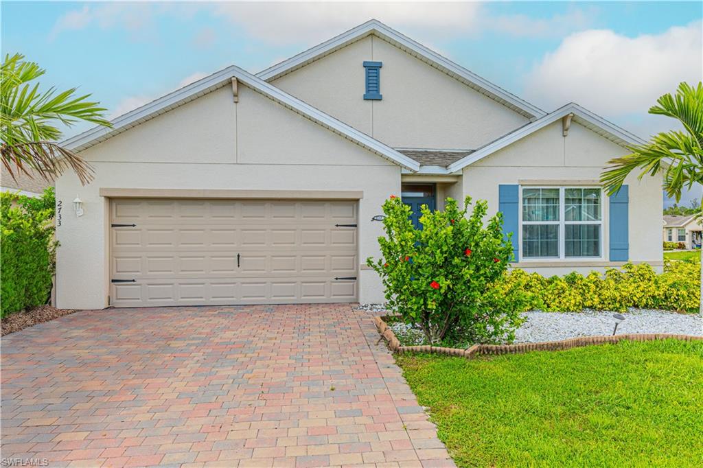 a front view of a house with a yard and garage