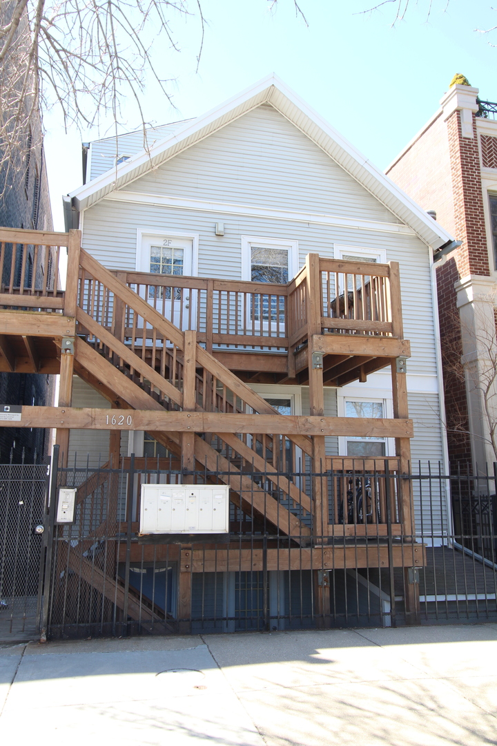 a view of a house with wooden fence