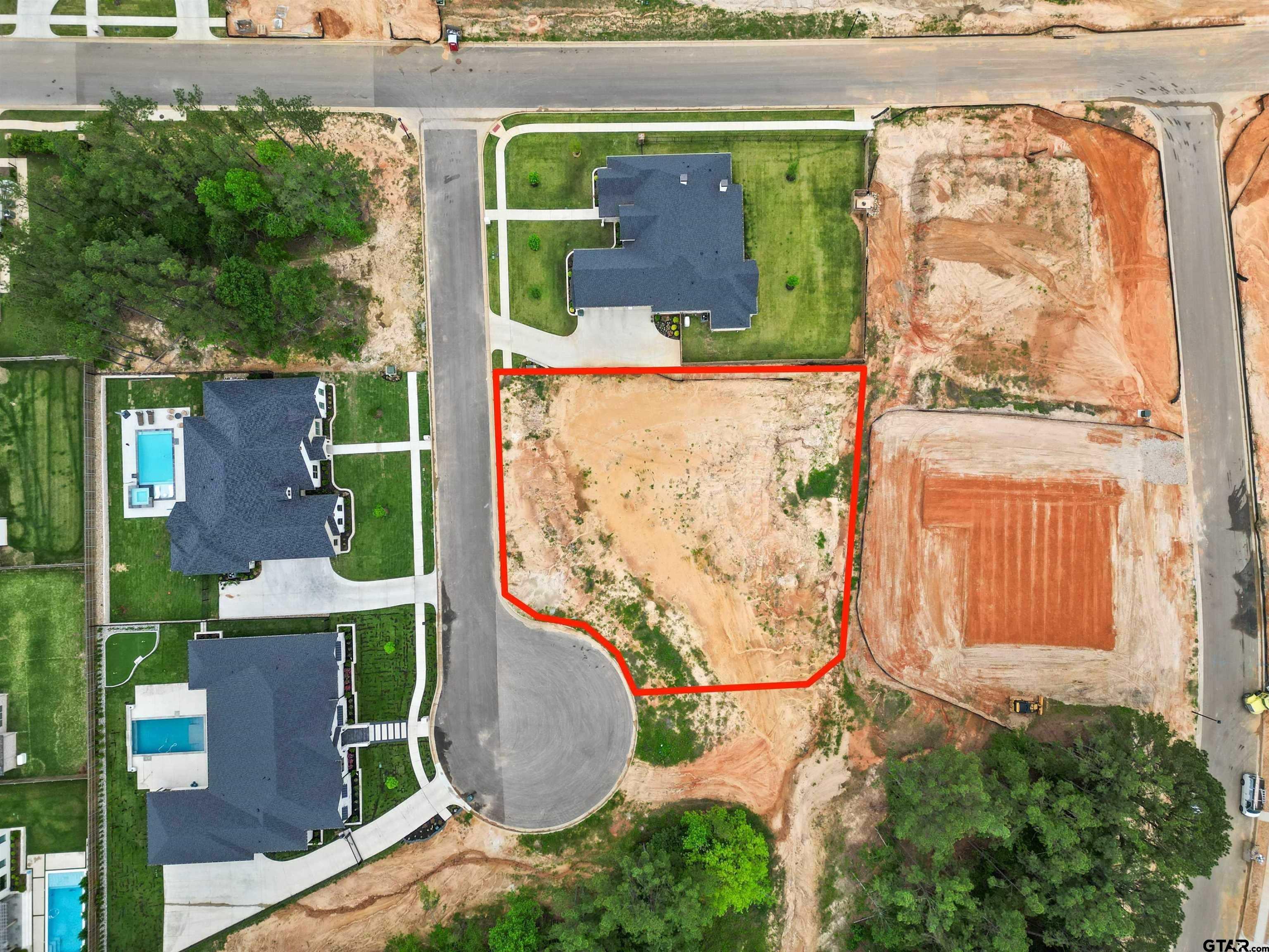 an aerial view of a house with a yard and a garage