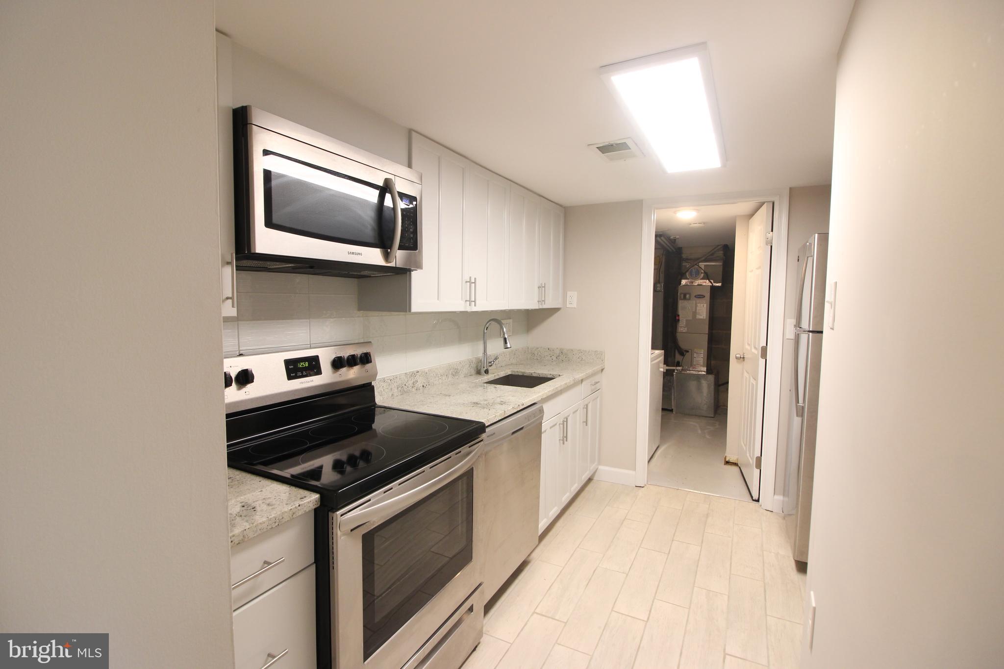 a kitchen with a stove and a microwave