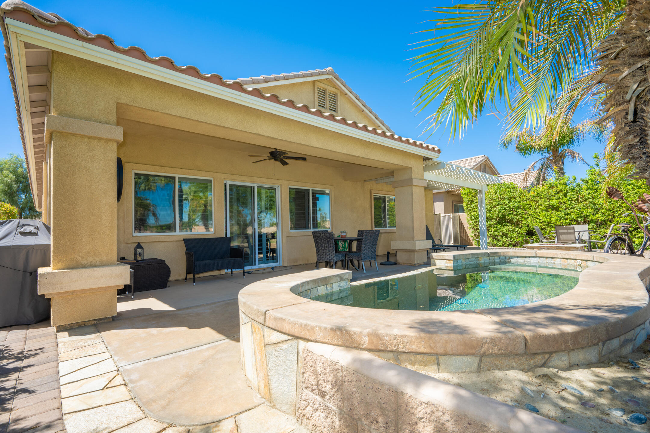 a view of a house with swimming pool and sitting area