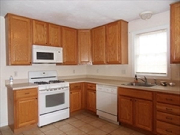 a kitchen with sink cabinets and window