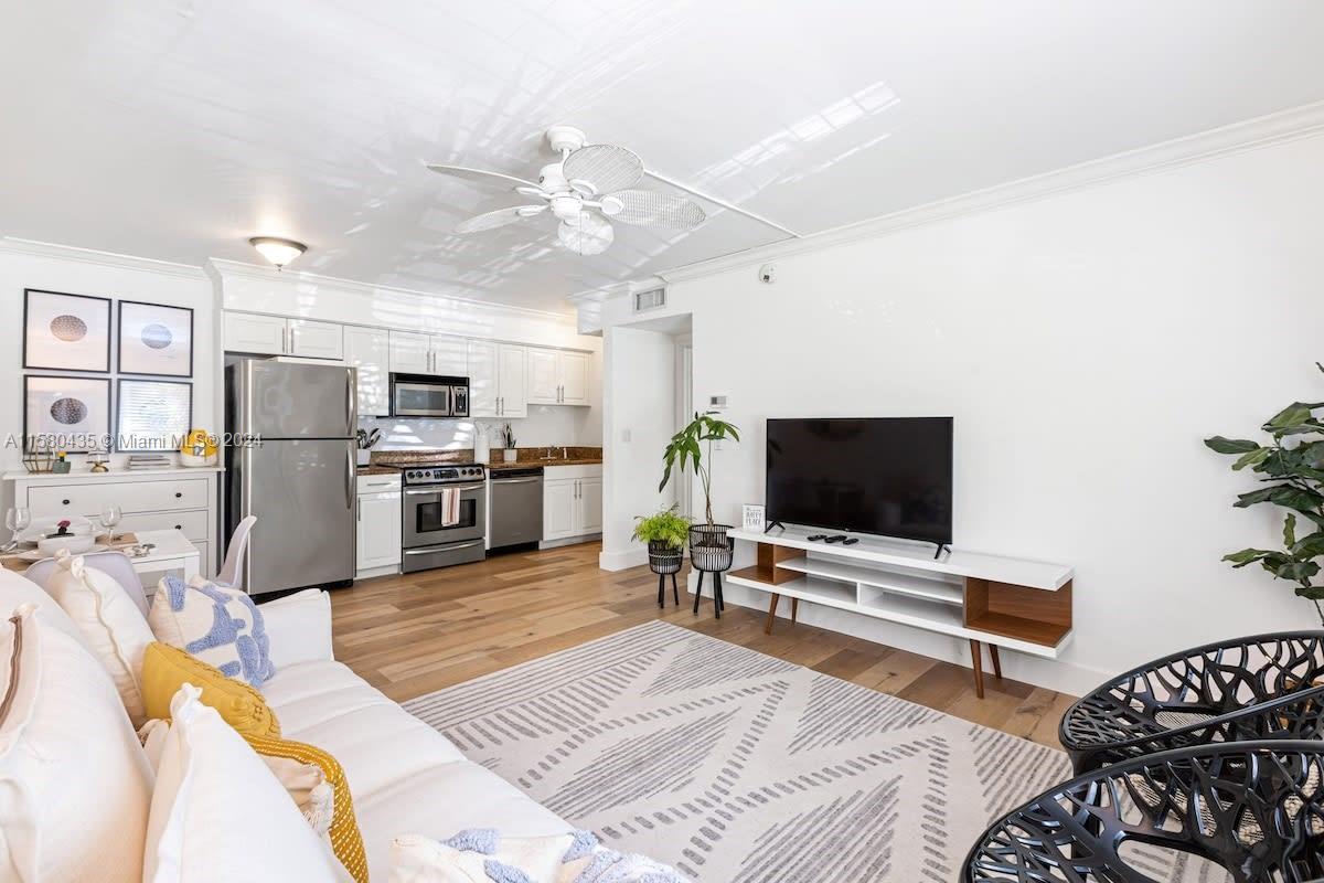 a living room with furniture and kitchen view