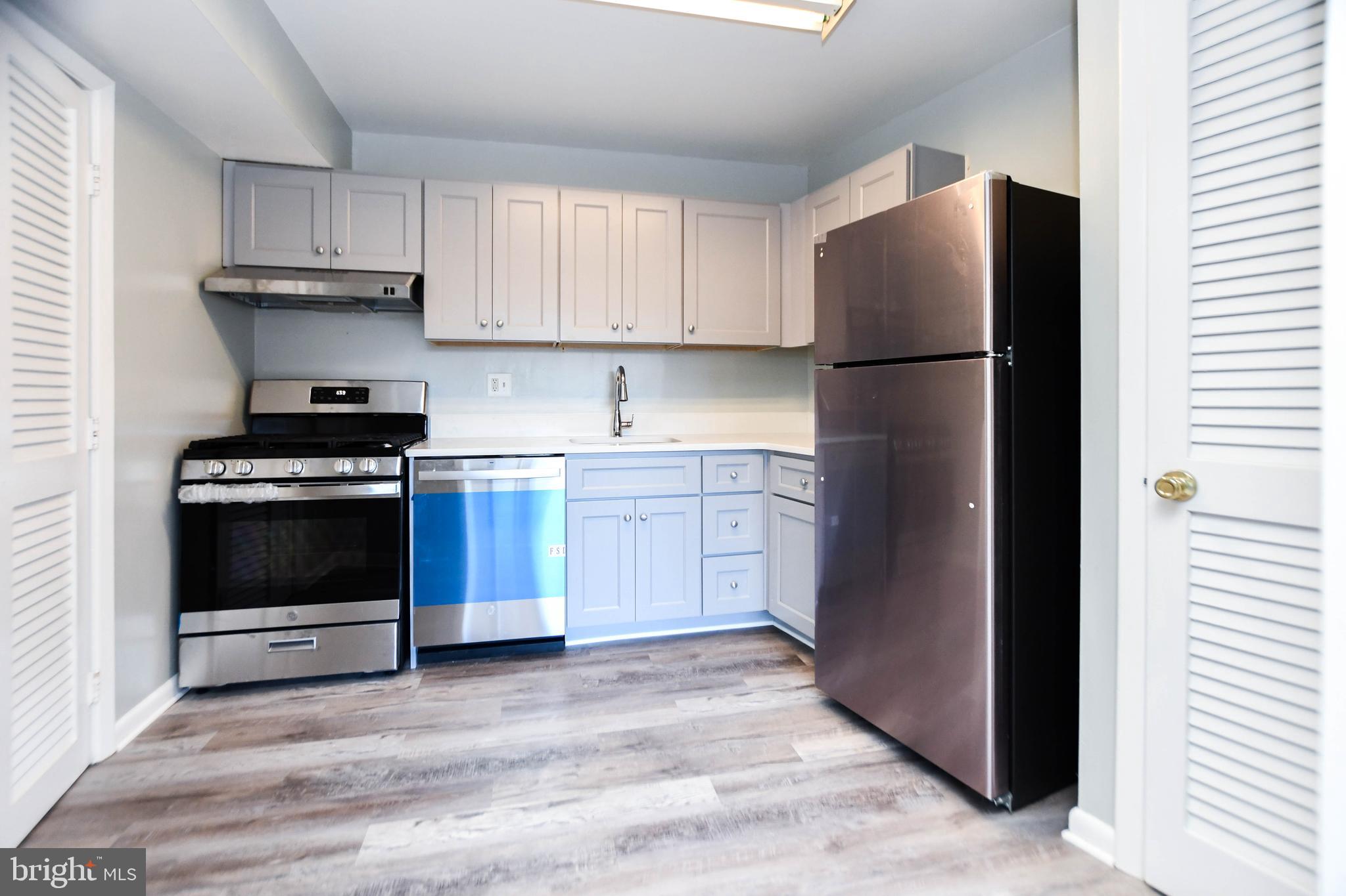 a kitchen with a cabinets and a stove top oven