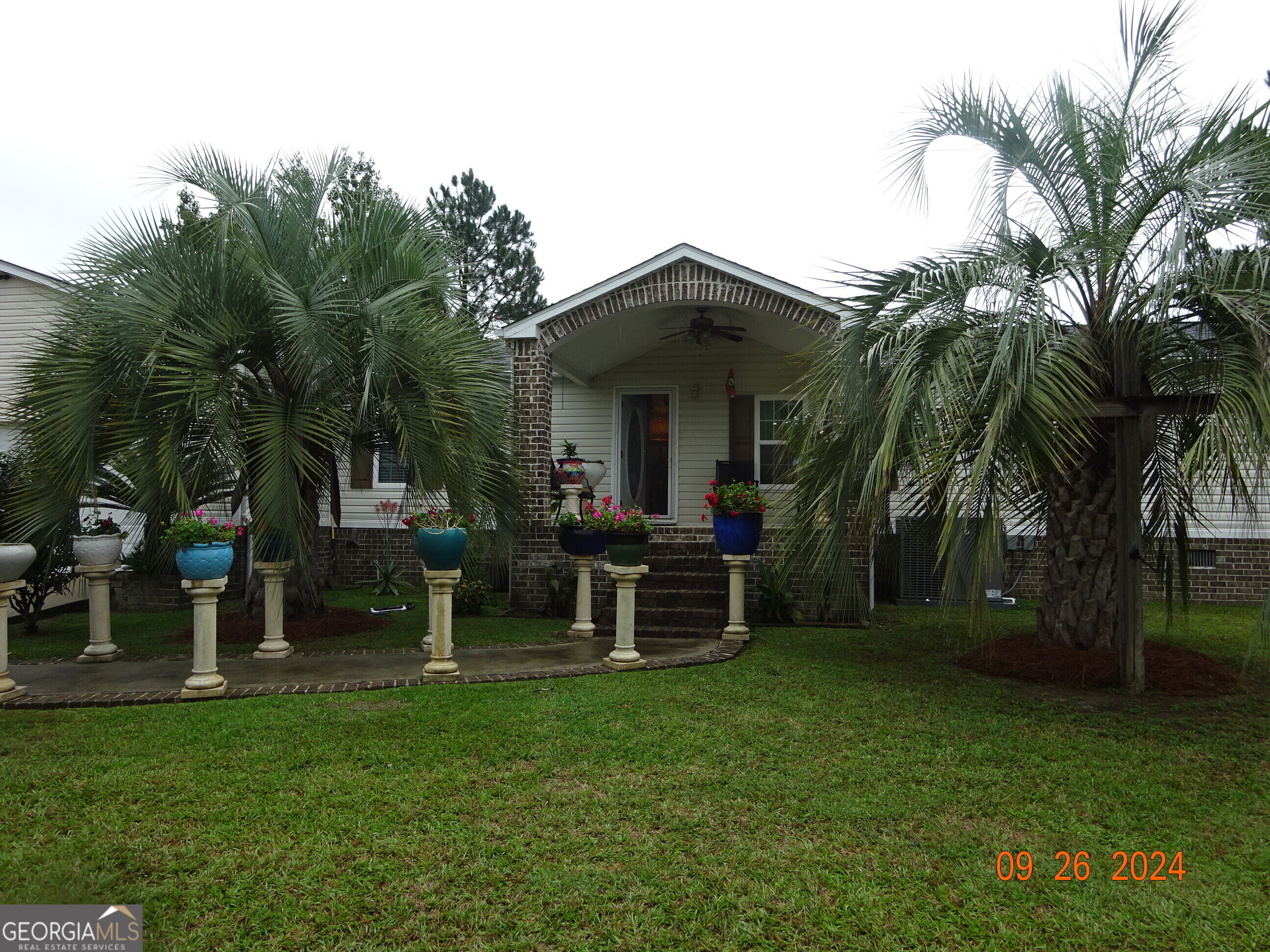 a view of a house with a yard and sitting area