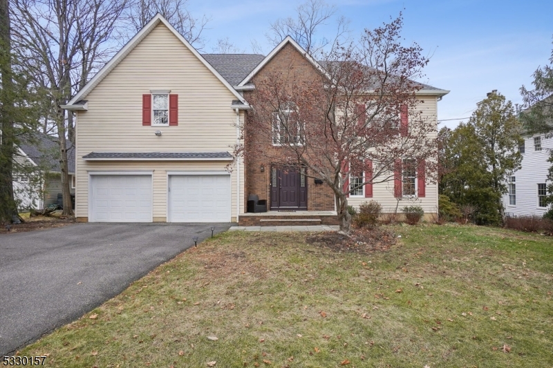 a view of a house with a yard and garage