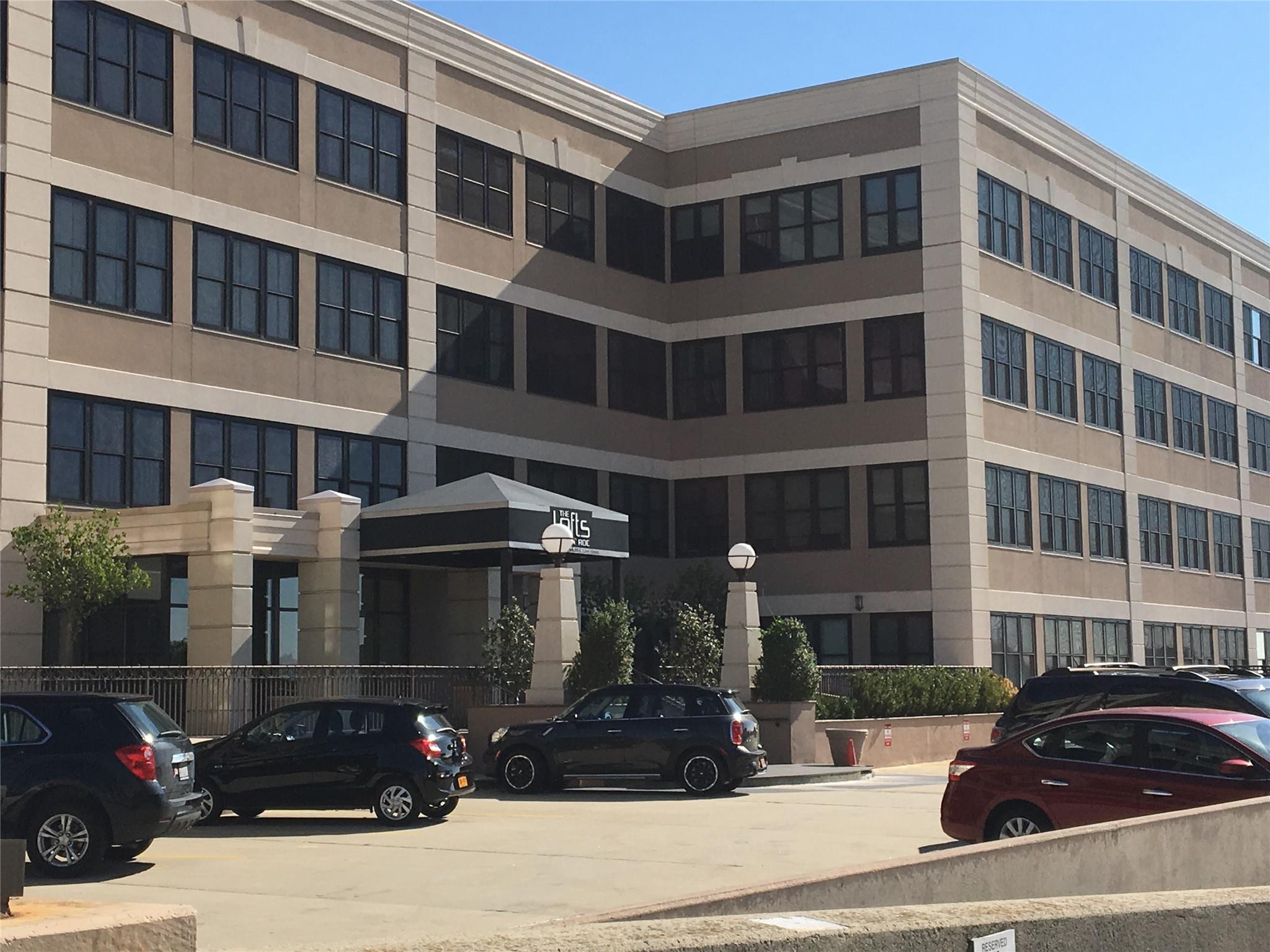 a couple of cars parked in front of a building