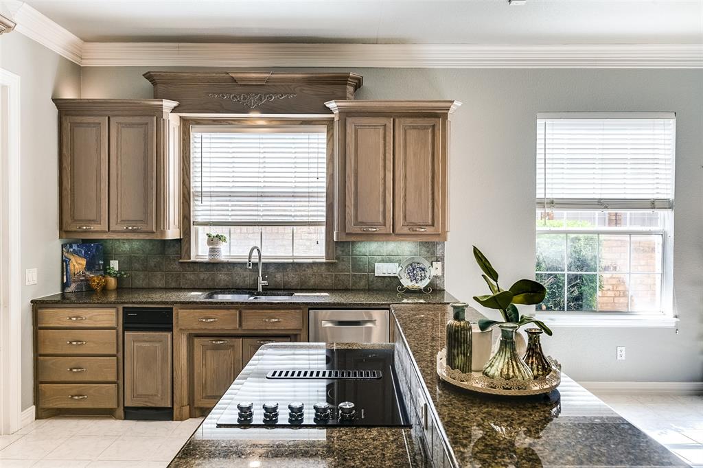 a kitchen with a sink stove and cabinets