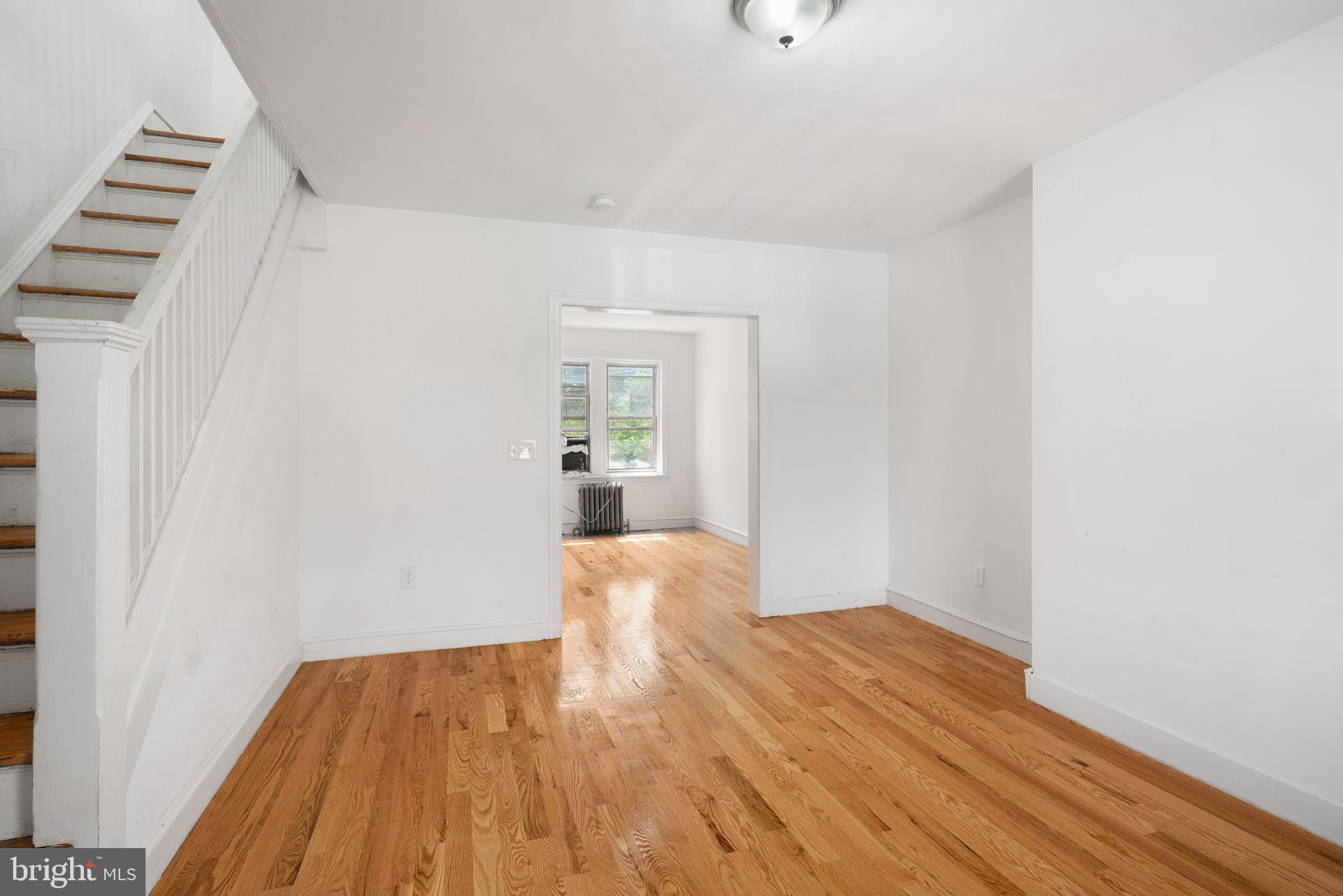 a view of wooden floor and windows in a room