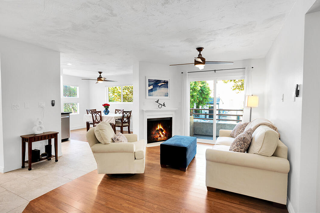 a living room with furniture a fireplace and a window