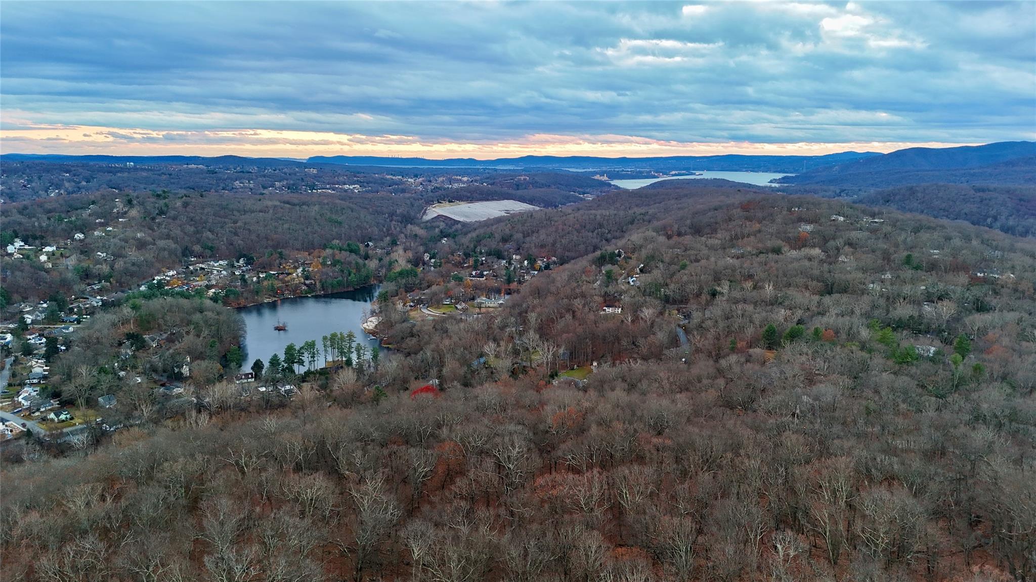 Aerial view at dusk featuring hudson river. ** Note not actual view of the property