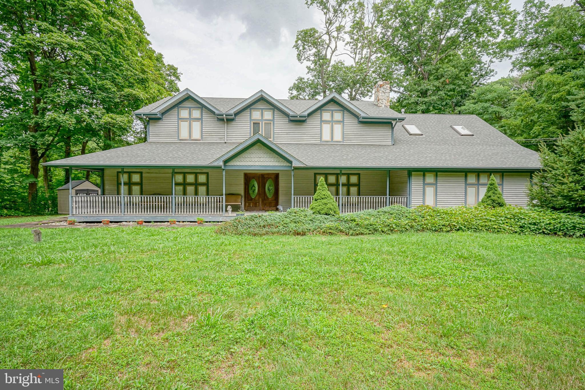 a front view of a house with yard and green space