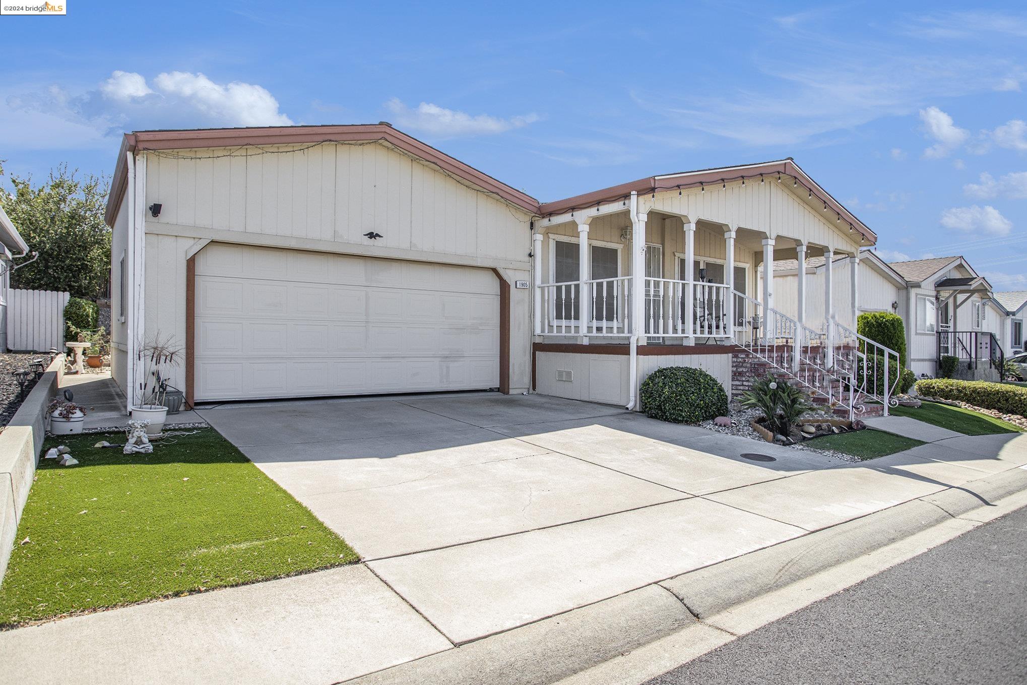 a front view of house with garage and yard