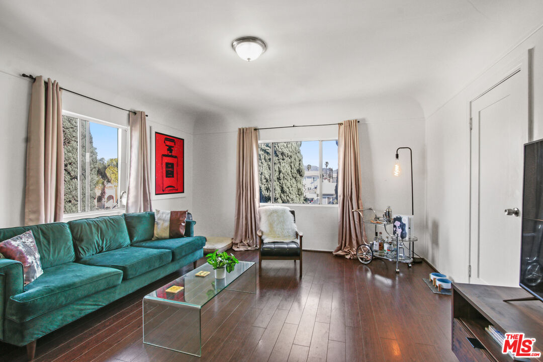 a living room with furniture and wooden floor