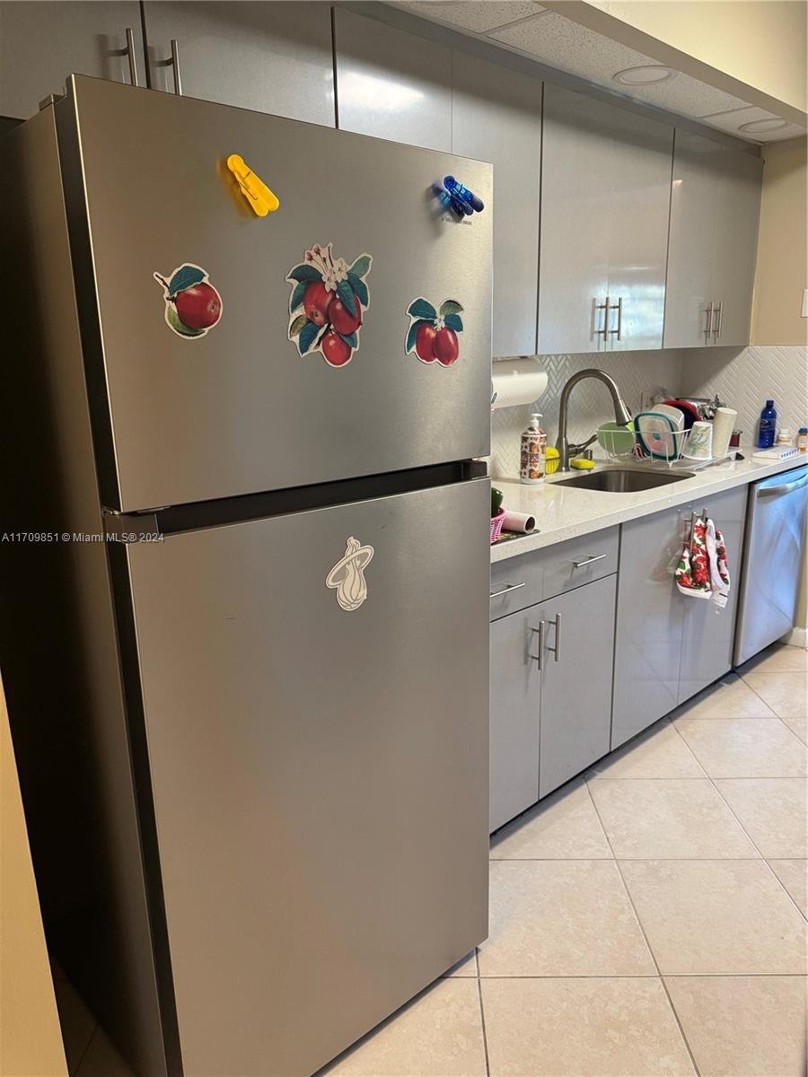 a white refrigerator freezer with a sink