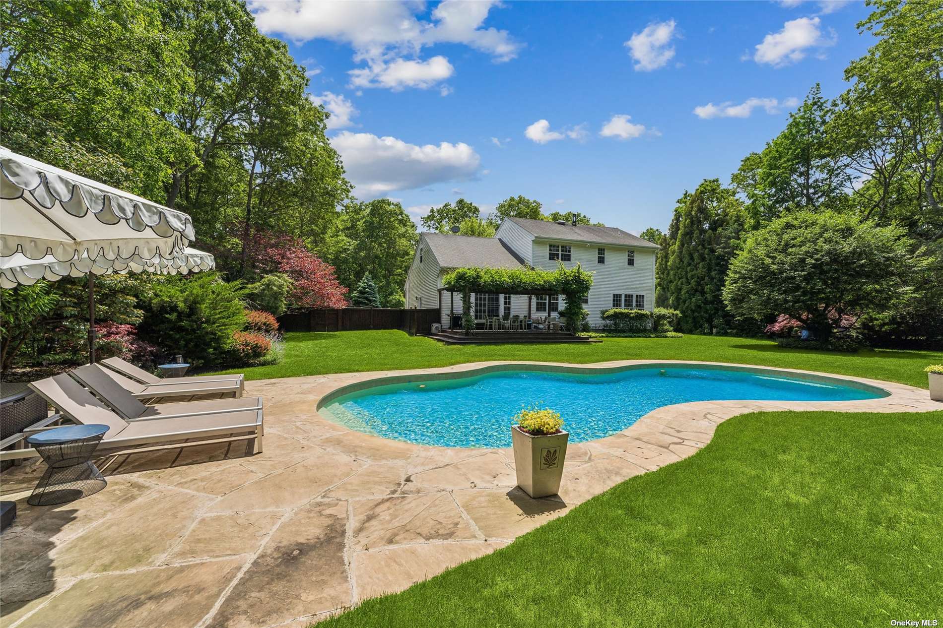 a view of a building with swimming pool and yard