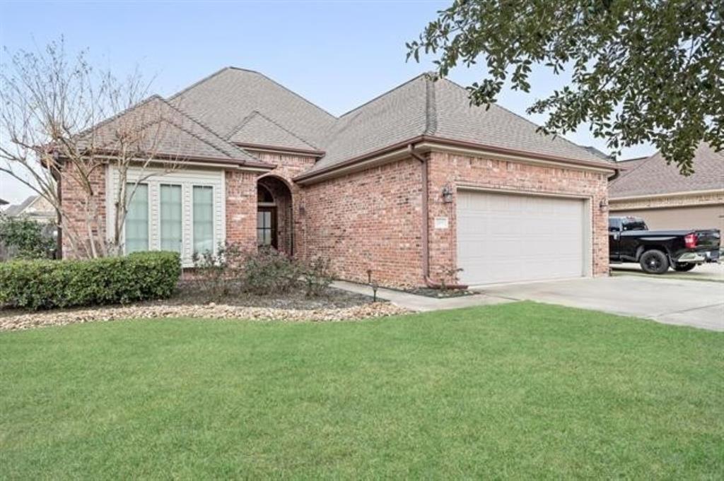 a front view of a house with a yard and garage