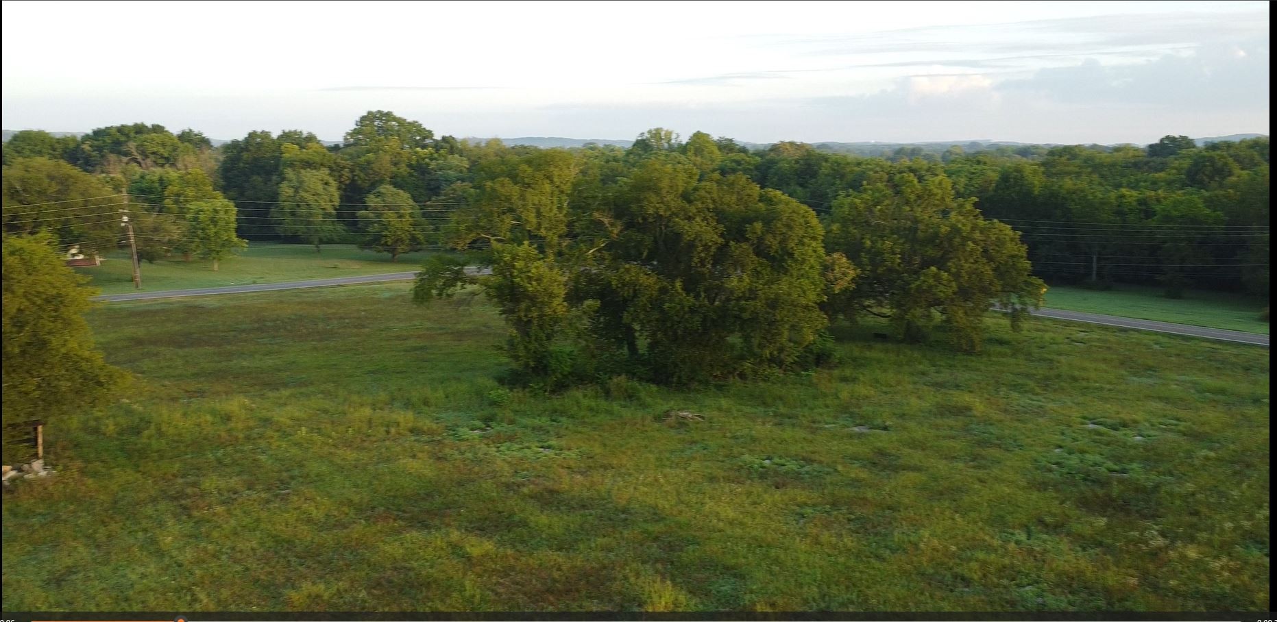 a view of a big yard with lots of green space