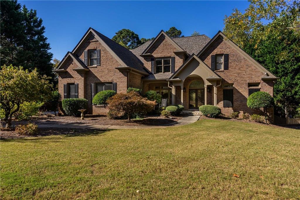 a front view of a house with yard porch and garage