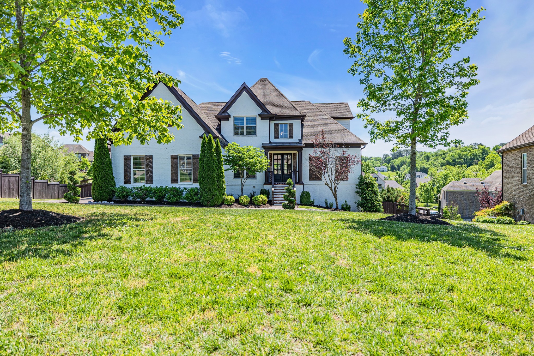 a front view of house with yard and green space