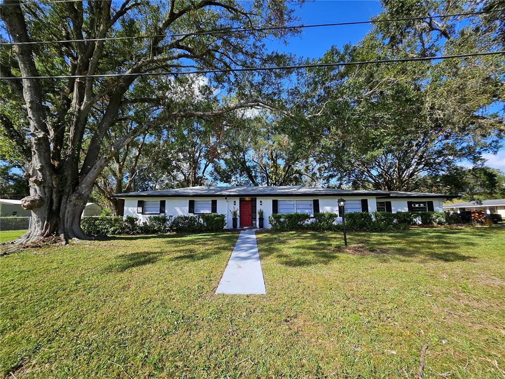 a view of a house with swimming pool and a yard