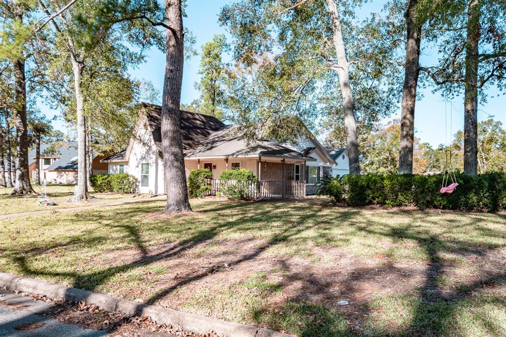 a front view of a house with a yard and trees